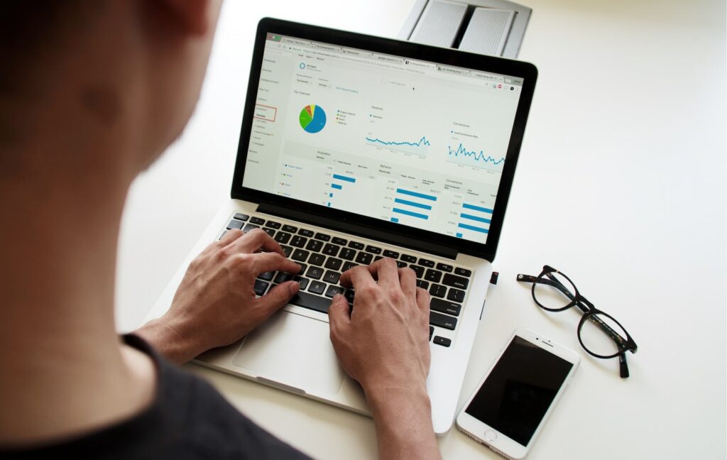 Man sitting at computer, looking at analytics